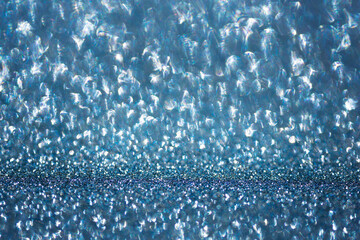 Obraz premium abstract defocused blue and silver glitter texture with soft round bokeh lights and a vibrant shimmering atmosphere providing ample space for text placement for festive holiday and winter marketing