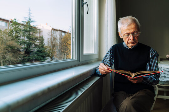 Senior man reading by the window