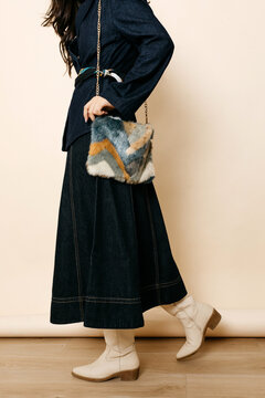 Woman holding fur shoulder bag 