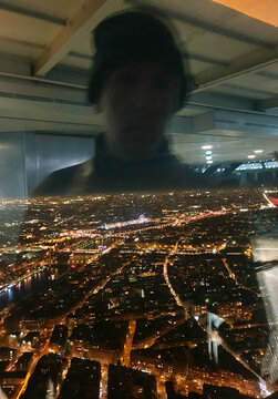 Silhouette over Parisian view from the top of the Eiffel Tower.