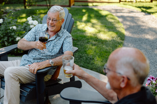 Candid moment of friends toasting outdoors in a garden