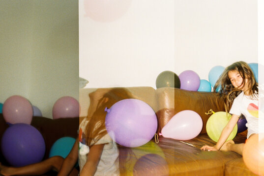 Happy child plays with balloons at home