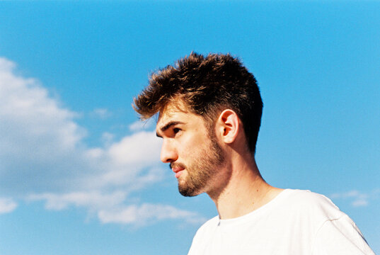 Film portrait of man against blue sky