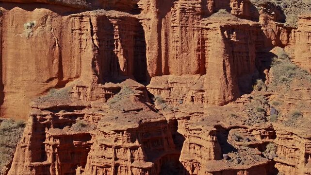 Stunning rock formations and geological strata define Kyrgyzstan's arid landscape. Daytime natural light illuminates the rugged canyon, showcasing its serene beauty.