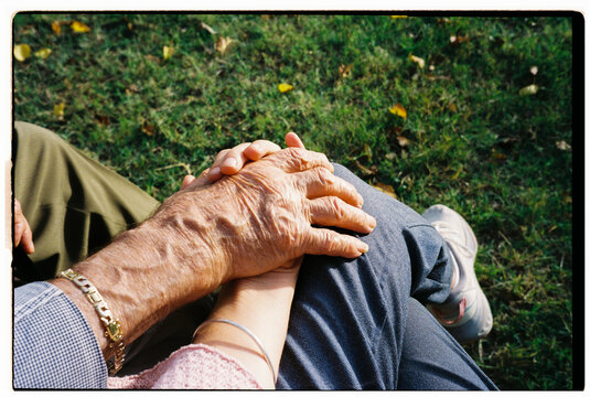 Elderly Hand Holding young hand. Family. Film