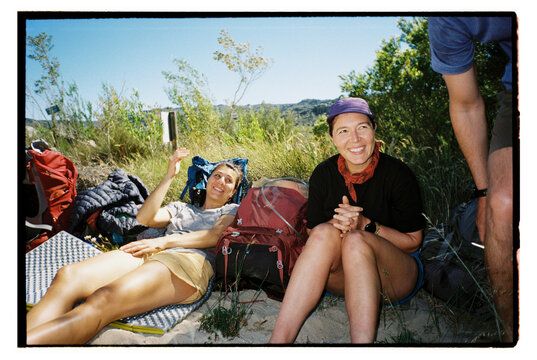 Happy hikers rest while on an outdoor travel adventure