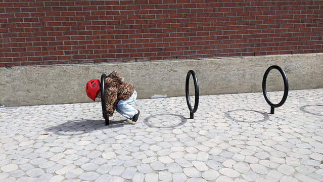 Child Playing on Bike Rack Rings Outdoors
