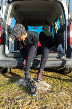 Woman gearing up for a mountain biking adventure