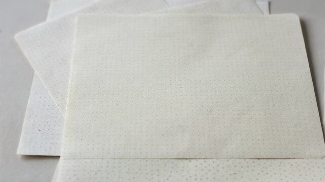 Medium shot of dot grid notebook sheets revealing subtle dot patterns for flexible layouts bullet journaling and creative freedom in planning.