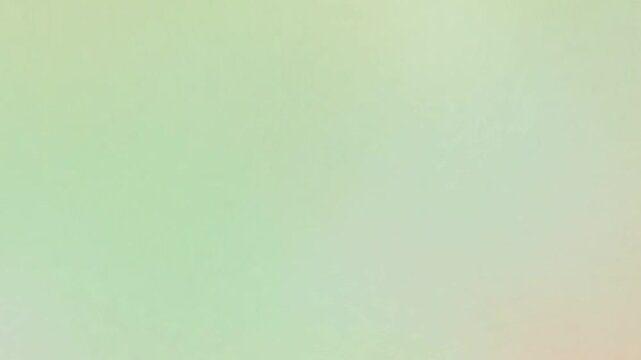 Soft abstract pastel gradient background with delicate green and peach hues. Smooth color wash creates a tranquil and ethereal backdrop