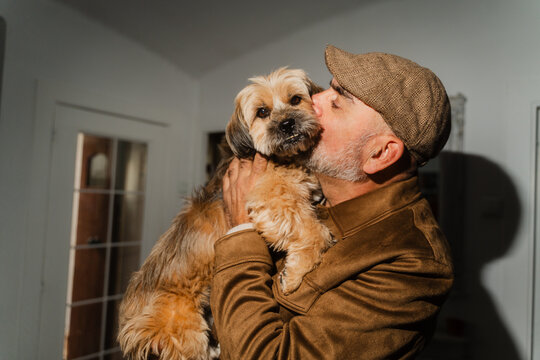 Portrait of a man carries his dog