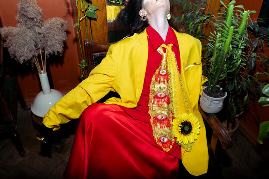 woman in a red dress and yellow jacket