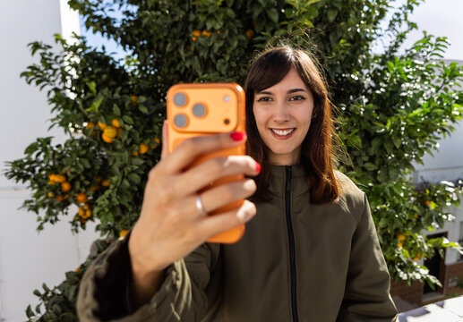 Wide angle portrait of a woman uses a smart phone