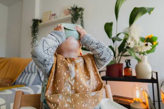Baby drinking from bowl making a mess