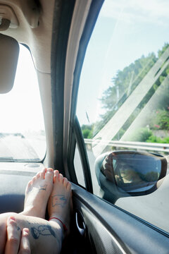 Feet Resting on Car Window During travel