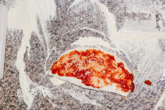 Preparing Calzone Dough With Sauce