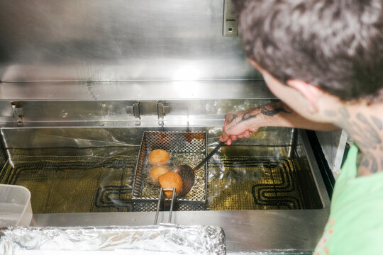 Cooking Small Round snacks in a Kitchen