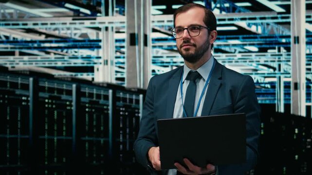 Happy data center programmer using laptop and AR tech to monitor error logs, debugging systems. Cheerful server hub employee running diagnostics checks on wireframe mesh infrastructure, camera A