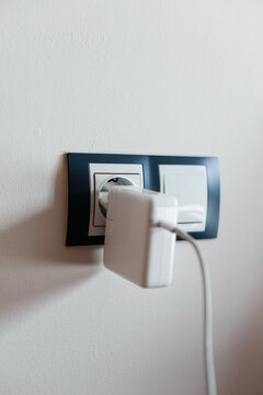 Charger connects to outlet for laptop power supply