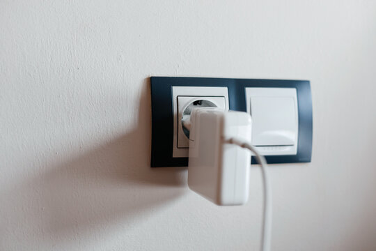 Charger connects to outlet for laptop power supply