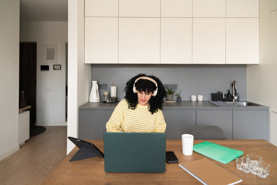 Woman working from home in cozy kitchen setting