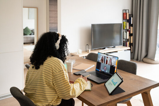 Remote work setup with video call and tablet charts