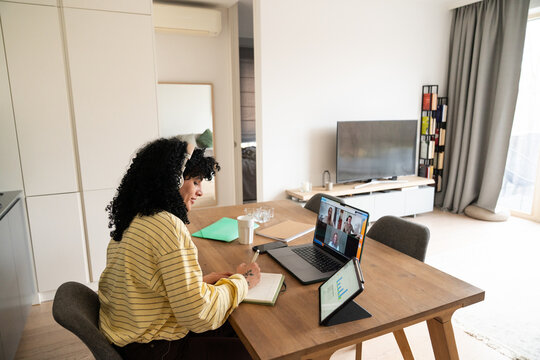 Remote work scene with video call and notes