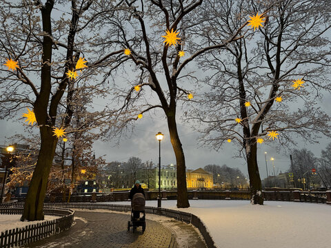 Winter stroll with lights in a snowy park setting