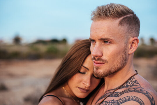 Couple embracing in a serene outdoor setting