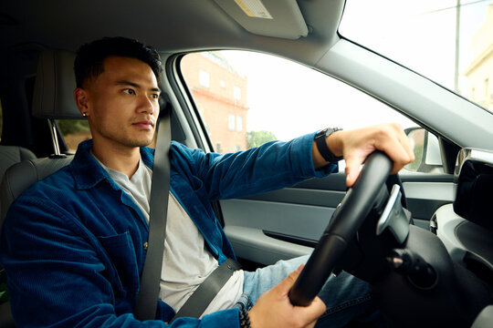 Good-looking man drives his car.