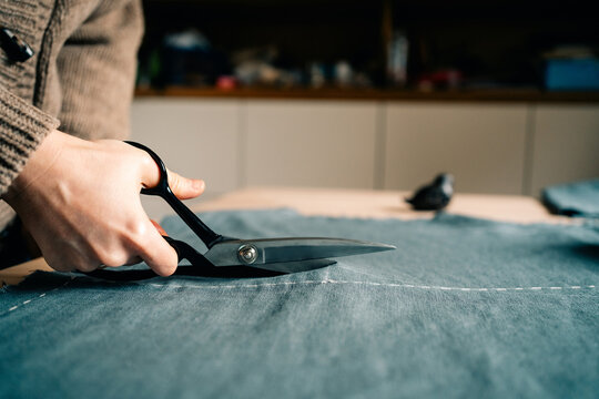 Cutting Denim Fabric for a Sewing Project in a Workshop