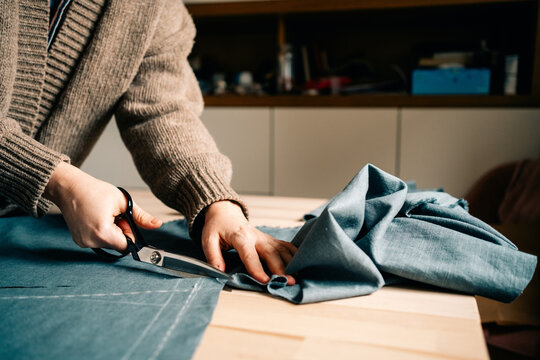 Cutting Fabric in a Cozy Workspace for Sewing Project