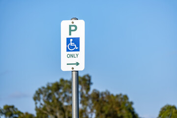Accessible parking sign indicating reserved parking for people with disabilities on a public street in Melbourne, Australia. Accessibility infrastructure, inclusive design, and parking regulation