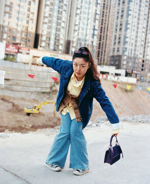 Young Chinese woman in denim clothing in a funky pose 