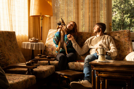 Couple playing with dog