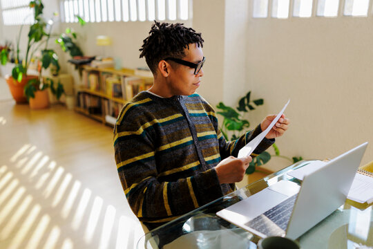 Man reading document working from home office