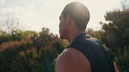 Athlete Outdoors In Sunlit Field During Workout