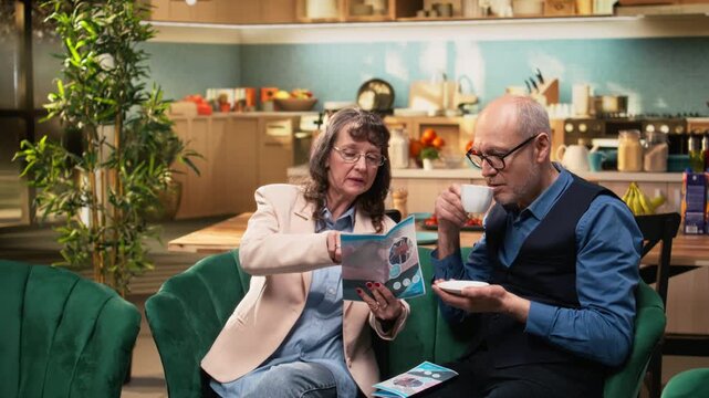 Senior people reading medical leaflet at home for healthcare advice, treatment recommendations and prevention guidance. Elderly wellbeing and daily living ensuring longevity and recovery.