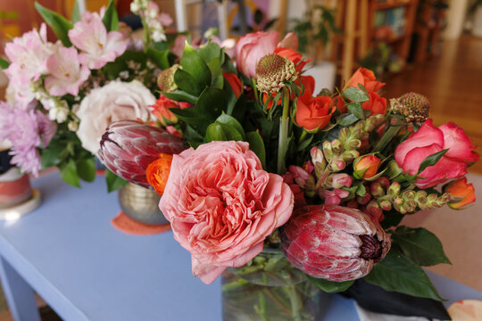 Cozy Indoor Floral Display With Roses and Proteas