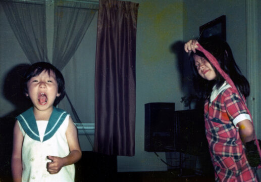 Playful Siblings Being Silly Indoors in the 1970s