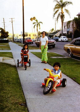 Kids Riding Tricycles and Big Wheel on Neighborhood Sidewalk
