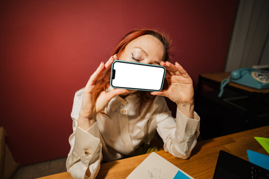 Businesswoman holding a mockup phone