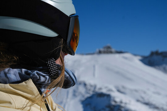 Close-up of a skier&rsquo;s reflective visor with snow-covered mountains