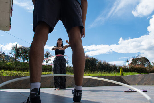 Hula Hoop Practice Under Clear Blue Sky in Outdoor Setting