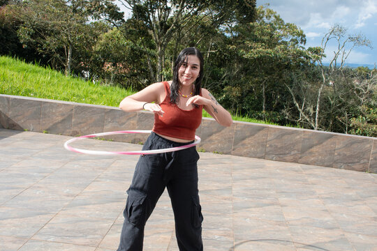 Hula Hooping Fun on a Sunny Day in a Scenic Outdoor Setting