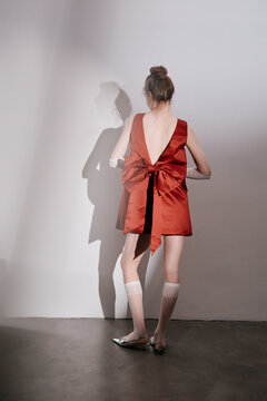 Woman in fancy red dress with oversized bow
