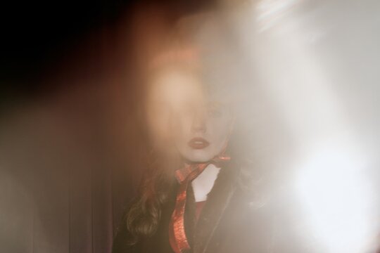 Ethereal woman portrait with festive ribbon and glow light