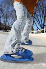 Legs of young woman on skating rink