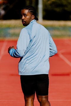 Back view of a runner lookign at camera during an outdoor workout