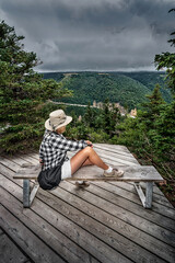 Fototapeta premium Hiker Resting at Scenic Lookout on Coastal Hiking Trail